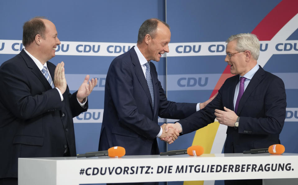 From left, candidate Helge Braun, new elected party chairman Friedrich Merz and candidate Norbert Roettgen, attend a press conference of the German Christian Democratic Party (CDU) at the party's headquarters in Berlin, Germany, Friday, Dec. 17, 2021 to announce the results of a ballot on who will become its new leader. (AP Photo/Michael Sohn)