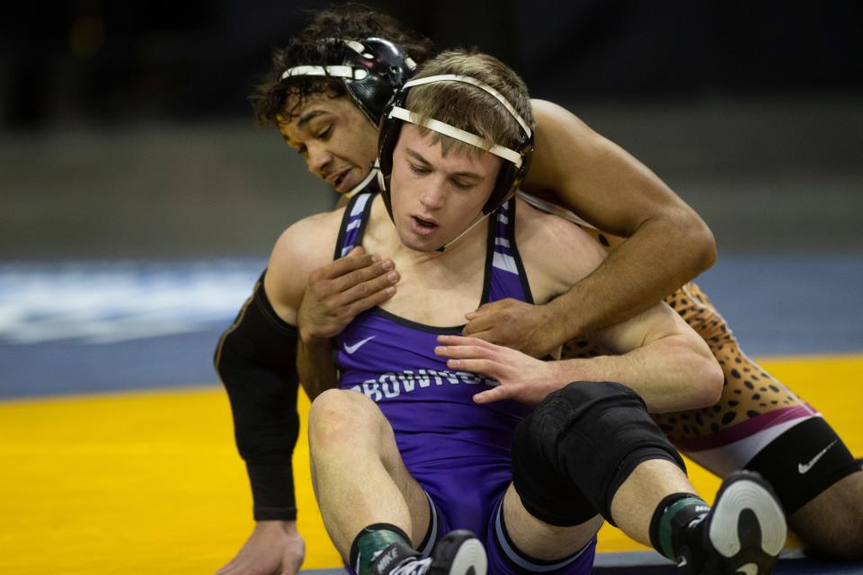 Zar Walker of Mishawaka and Parker Reynolds of Brownsburg compete in the 144-pound quarterfinal round of the 2023-24 IHSAA State Wrestling tournament at Ford Center in Evansville, Ind., Saturday, Feb. 17, 2024.