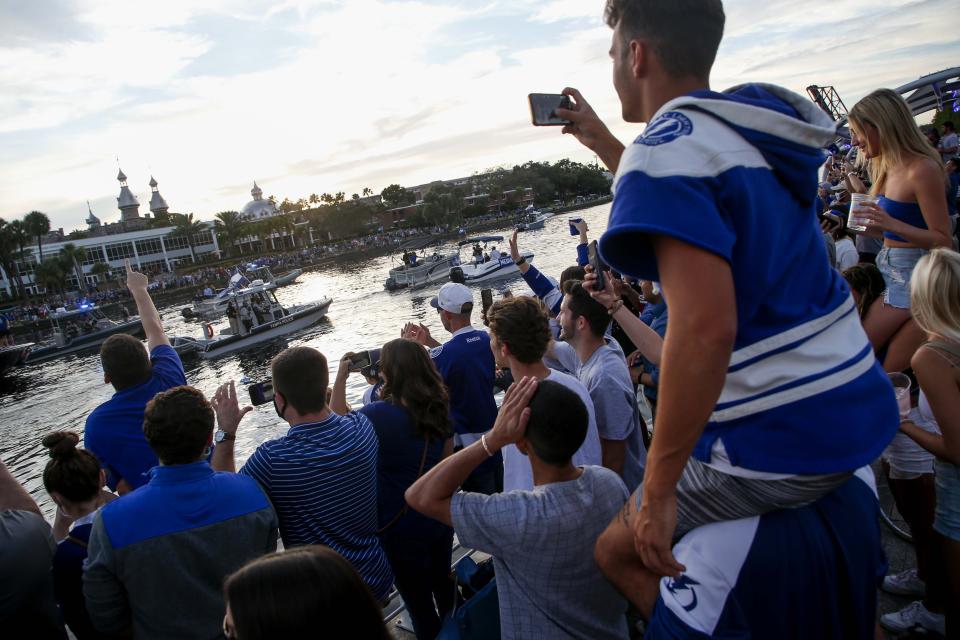 Tampa Bay Lightning fans gather along the Tampa Riverwalk during the NHL hockey Stanley Cup champions' boat parade, Wednesday, Sept. 30, 2020, in Tampa, Fla. (Ivy Ceballo/Tampa Bay Times via AP)