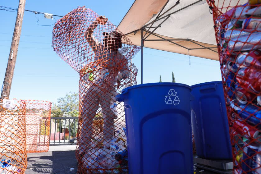 Pasadena, CA - July 11: Jesus Alonzo works at a recycling center in the Superior Grocers parking lot on Tuesday, July 11, 2023 in Los Angeles, CA. (Dania Maxwell / Los Angeles Times).