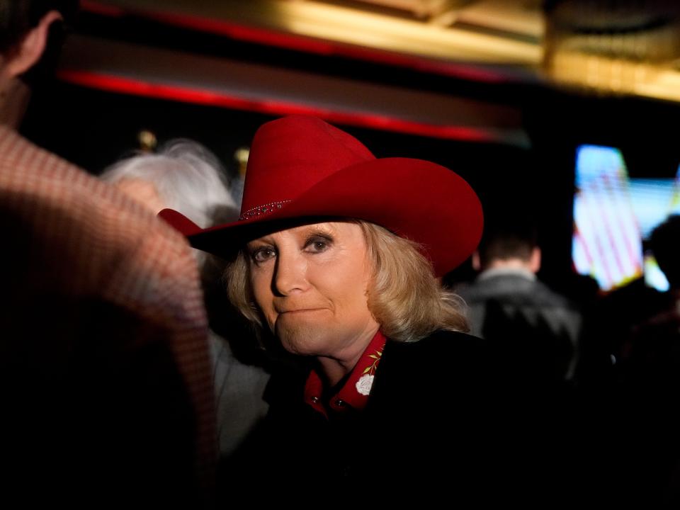 Donna Fiducia walks in the ballroom at a Herschel Walker election night watch party on Tuesday, Nov. 8, 2022, in Smyrna, Ga. Republican U.S. Senate candidate Walker is running against Democratic Sen. Raphael Warnock.