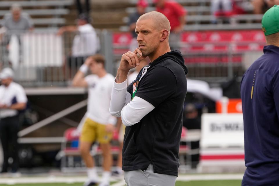 Sep 3, 2022; Columbus, Ohio, USA;  Former Ohio State linebacker James Laurinaitis, now a coach with the Notre Dame Fighting Irish, watches as his team warms up prior to the NCAA football game against the Ohio State Buckeyes at Ohio Stadium. Mandatory Credit: Adam Cairns-USA TODAY Sports