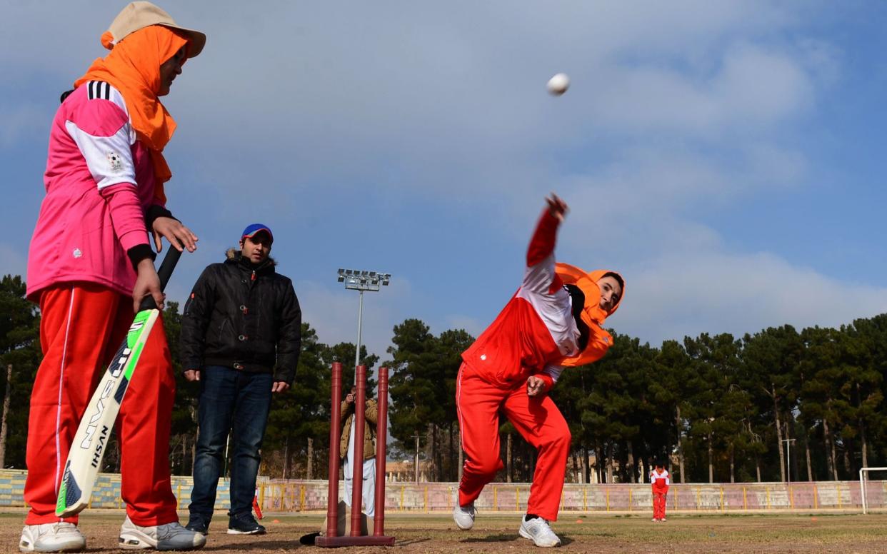 Afghan women play cricket at the grounds of the stadium in Herat in 2015