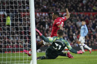 Manchester United's Anthony Martial, center top, tries to score past Manchester City's goalkeeper Ederson, bottom, during the English Premier League soccer match between Manchester United and Manchester City at Old Trafford in Manchester, England, Sunday, March 8, 2020. (AP Photo/Dave Thompson)