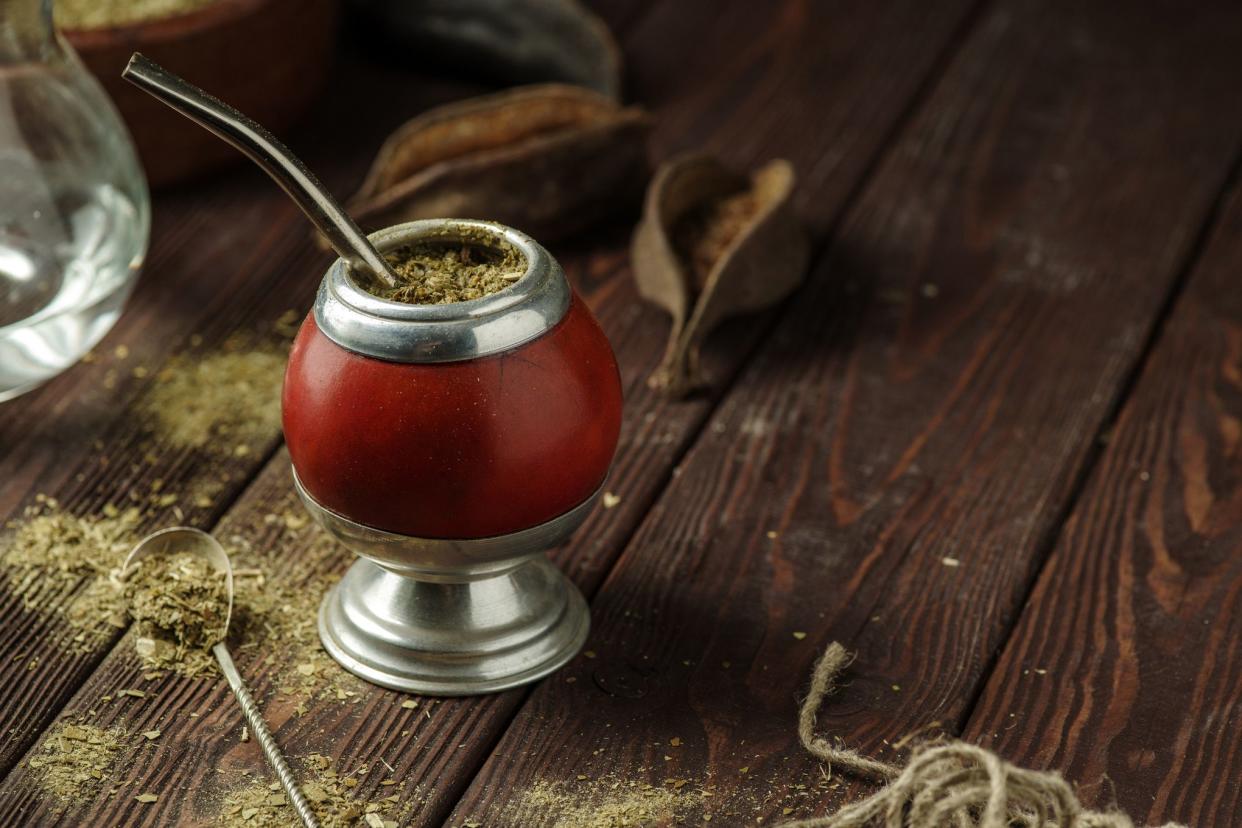yerba mate in calabash gourd on wooden table