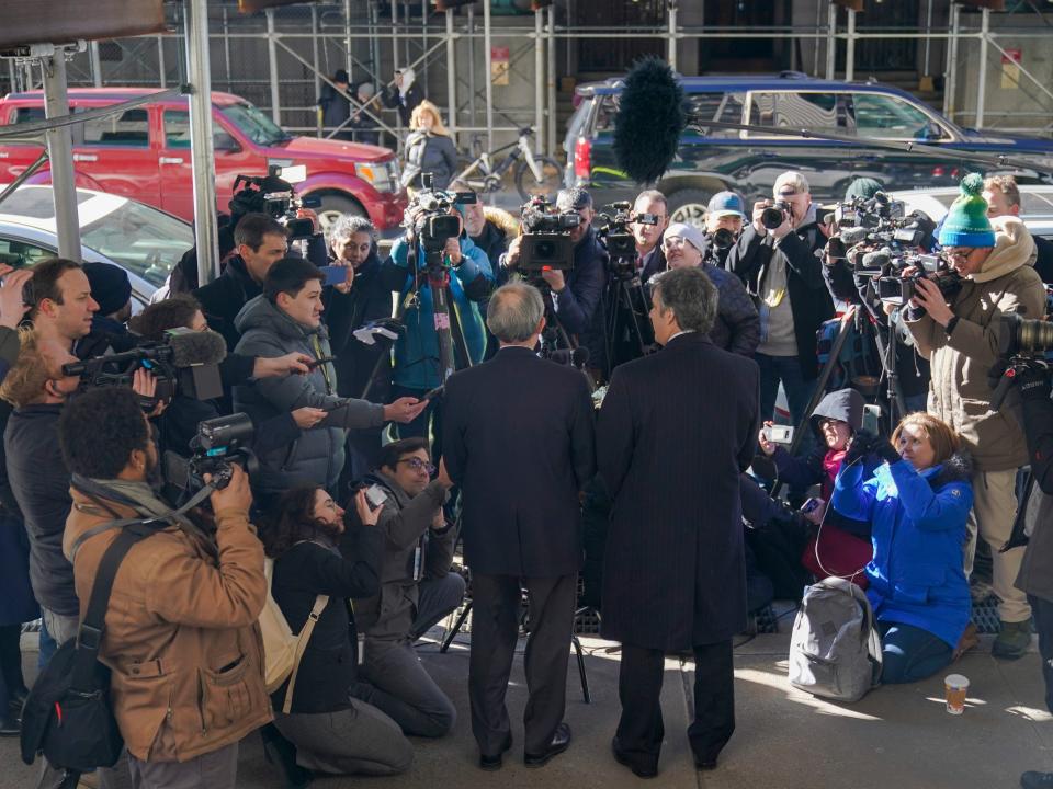 Donald Trump's former lawyer and fixer, Michael Cohen, right, and Cohen's lawyer, Lanny Davis, left, face a ravening press corps outside the Trump 'hush money' grand jury in Manhattan.