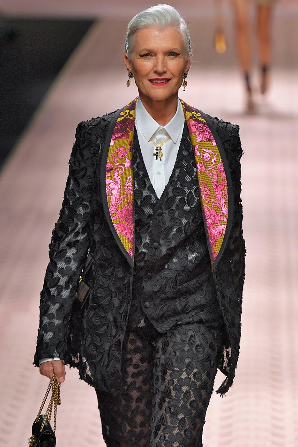 Maye Musk wearing a black suit walking the runway