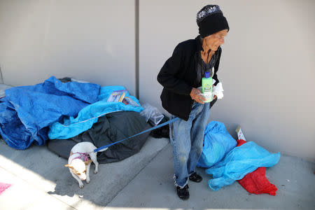 Carmen Ramirez, 78, stands in front of the tent in which she sleeps on the street in Los Angeles, California, U.S. March 29, 2018. Ramirez takes down her tent during the day to comply with city regulations. Picture taken March 29, 2018. REUTERS/Lucy Nicholson
