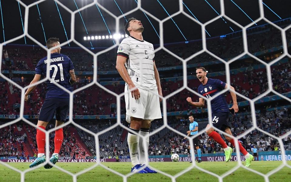 Mats Hummels of Germany looks dejected after scoring an own goal for France's first goal as Lucas Hernandez and Adrien Rabiot of France celebrate during the UEFA Euro 2020 Championship Group F match between France and Germany at Football Arena Munich on June 15, 2021 in Munich, Germany - Matthias Hangst/Getty Images