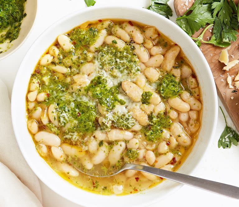 <p>White beans are a great blank canvas, especially for bright, assertive flavours like lemon and fresh herbs. Perfect as a side, or as a meal topped with a poached egg, these beans prove from-scratch really does make a difference.</p><p>Get the <a href="https://www.delish.com/uk/cooking/recipes/a33542298/cannellini-beans-recipe/" rel="nofollow noopener" target="_blank" data-ylk="slk:Cannellini Beans with Herb Sauce;elm:context_link;itc:0;sec:content-canvas" class="link ">Cannellini Beans with Herb Sauce</a> recipe.</p>