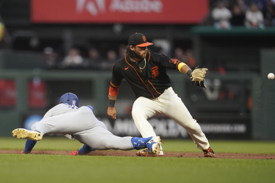 Los Angeles Dodgers' Joey Gallo, left, slides into second base after hitting a double next to San Francisco Giants shortstop Brandon Crawford during the second inning of a baseball game in San Francisco, Saturday, Sept. 17, 2022. (AP Photo/Jeff Chiu)