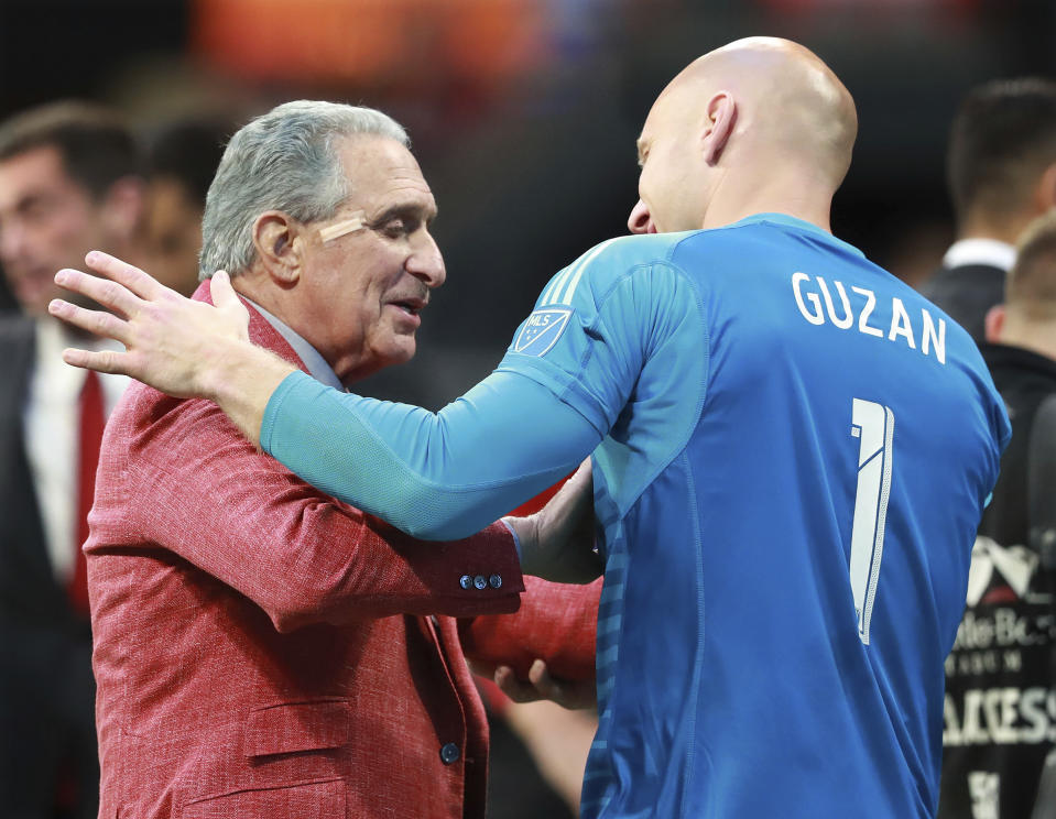 Atlanta United owner Arthur Blank, left, and goalkeeper Brad Guzan celebrate after clinching a playoff spot with a victory over the Chicago Fire in an MLS soccer match on Sunday, Oct. 21, 2018, in Atlanta. (Curtis Compton/Atlanta Journal-Constitution via AP)