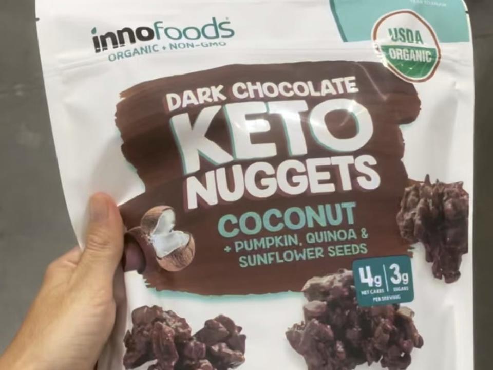 hand holding bag of chocolate keto nuggets at costco