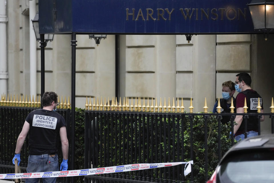 Police forensic officers inspect the entrance of the Harry Winston jewelry after a robbery in Paris, Saturday, May 18, 2024. French police investigators were hunting Saturday for armed robbers on motorbikes who hit a jewelry store on one of Paris' poshest streets, and media reports said the target was the exclusive Harry Winston boutique, self-described "Jeweler to the Stars." (AP Photo/Thibault Camus)