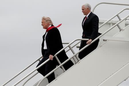 U.S. President-elect Donald Trump and Vice-President elect Mike Pence walk off Trump's plane upon their arrival in Indianapolis, Indiana, U.S., December 1, 2016. REUTERS/Mike Segar