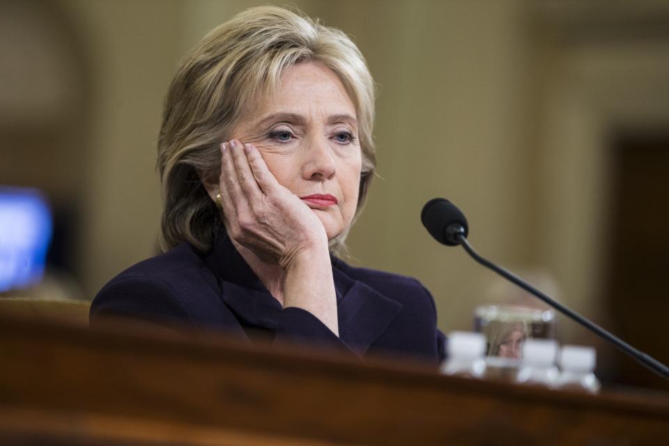 WASHINGTON, USA - OCTOBER 22: Former Secretary of State and Democratic Presidential Candidate Hillary Clinton looks at a piece of evidence on a monitor while testifying in front of the Benghazi Committee during a hearing on the attack in Washington, USA on October 22, 2015. (Photo by Samuel Corum/Anadolu Agency/Getty Images)
