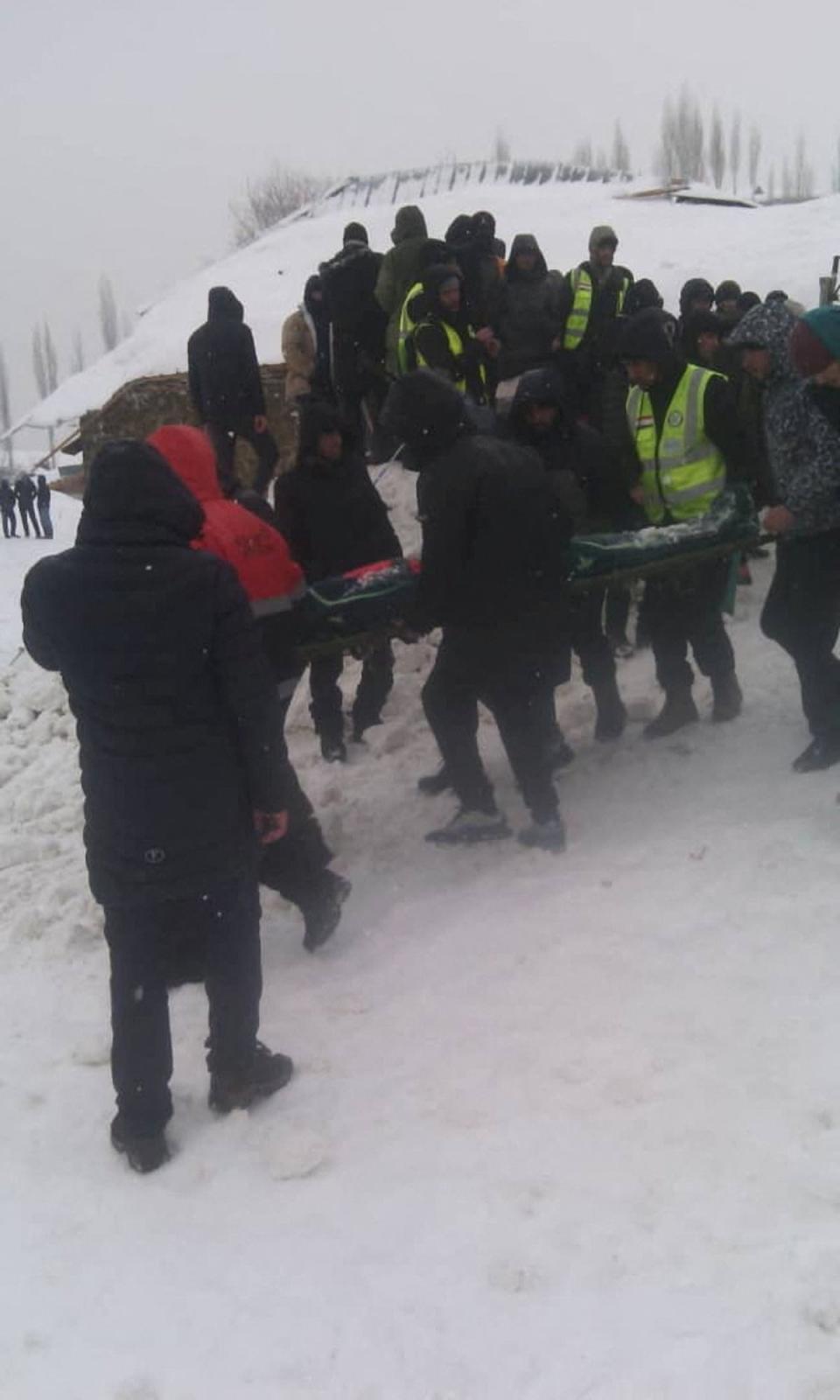 People take part in a rescue operation following an avalanche slide in Gorno-Badakhshan region (via REUTERS)