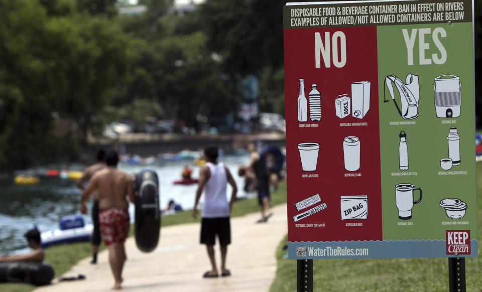 In a May 28, 2012 photo, a sign informs Memorial Day visitors to Prince Solms Park in New Braunfels,Texas, what is acceptable for tubers to carry down the Comal river. Drinking beer while lazily floating through New Braunfels is a heat-beating tradition for hundreds of thousands of vacationers each summer, but turnout is down and businesses say the reason is clear: a new ban on disposable containers. The so-called can ban doesn’t prohibit alcohol, but that message hasn’t been sticking. (AP Photo/San Antonio Express-News, John Davenport) MAGS OUT NO SALES SAN ANTONIO OUT