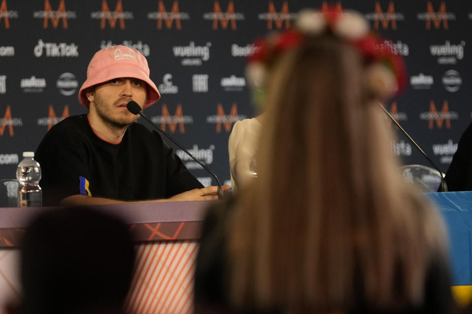 Oleh Psiuk, frontman of Ukraine's Kalush Orchestra answers to Iryna Shafinska, fan and member of the official Ukraine fan Club OGAE Ukraine during a news conference after winning the Grand Final of the Eurovision Song Contest at Palaolimpico arena, in Turin, Italy, Sunday, May 15, 2022. (AP Photo/Luca Bruno)