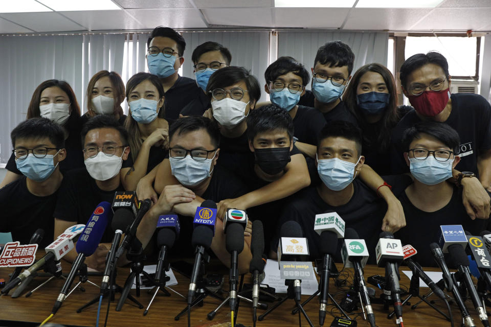 Young pro-democracy activists and localist candidates who were elected from unofficial pro-democracy primaries, including Joshua Wong, left, gather during a news conference in Hong Kong, Wednesday, July 15, 2020. At least 12 Hong Kong pro-democracy nominees including Joshua Wong were disqualified for a September legislative election, with authorities saying Wednesday, July 29, they failed to uphold the city's mini-constitution and pledge allegiance to Hong Kong and Beijing. (AP Photo/Kin Cheung)