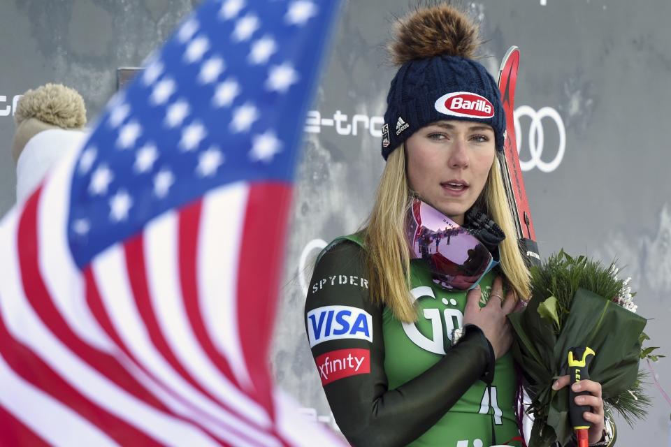 United States' Mikaela Shiffrin, winner of an alpine ski, women's World Cup giant slalom, listens to the national anthem, in Lienz, Austria, Saturday, Dec. 28, 2019. (AP Photo/Piermarco Tacca)