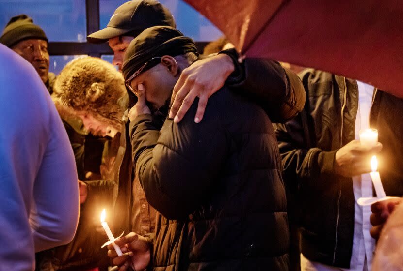 Family members console one another at a vigil for Keenan Anderson, who died after being tased by Los Angeles police.