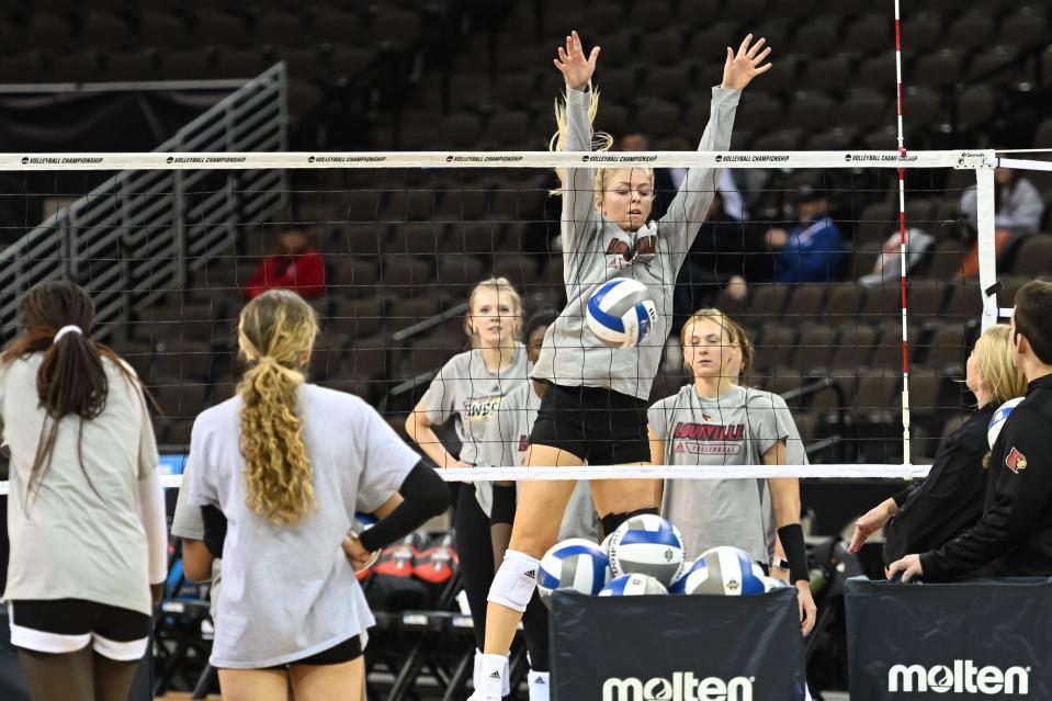 Louisville's Anna DeBeer practices blocks during Wednesday's open practice session at the NCAA Tournament at CHI Health Center in Omaha, Neb. Saturday night's championship match will pit the winner of Thursday's two national semifinals.