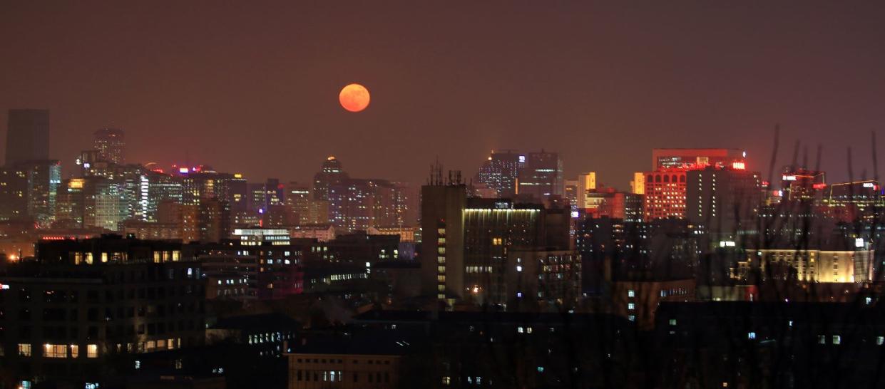 The moon over the Chinese capital, Beijing (PA)