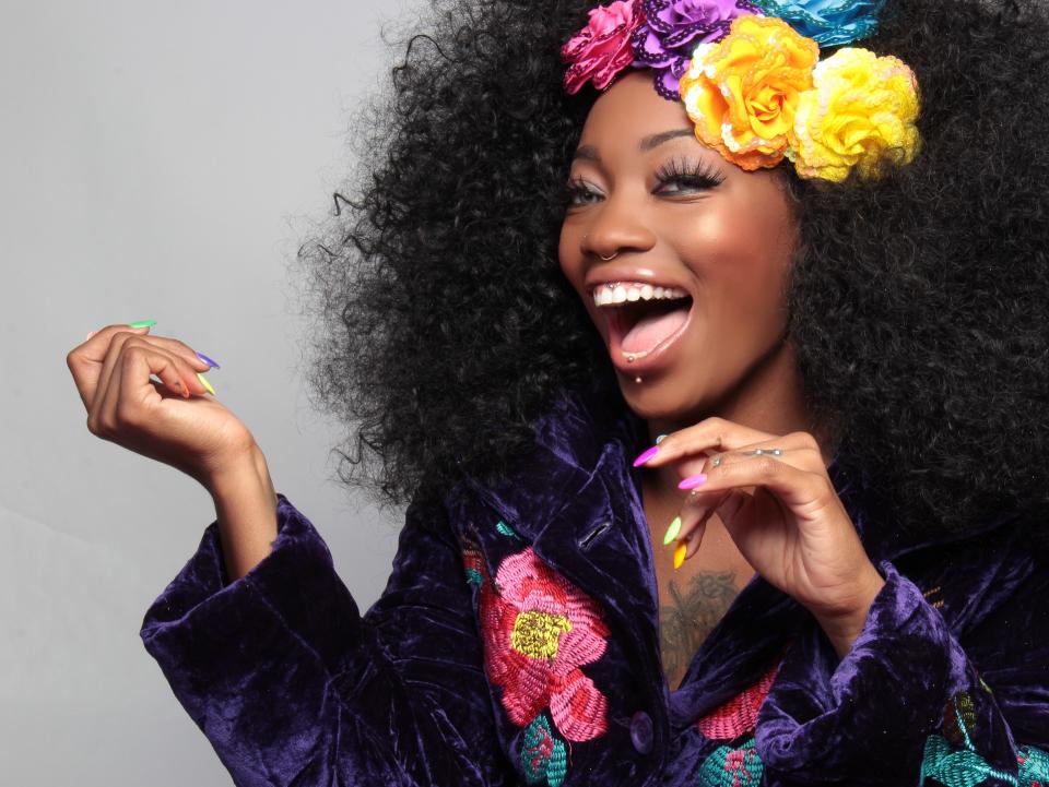 Woman laughing with flowers in hair