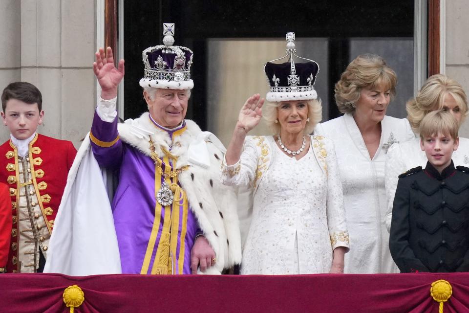 Britain’s King Charles III and Queen Camilla wave to the crowds from the balcony of Buckingham Palace after their coronation ceremony, in London.
