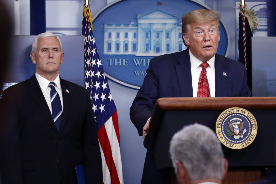 President Donald Trump speaks about the coronavirus in the James Brady Press Briefing Room of the White House, Thursday, April 16, 2020, in Washington, as Vice President Mike Pence listens. (AP Photo/Alex Brandon)