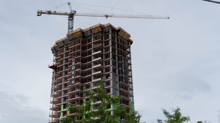 A high-rise apartment building is seen under construction on the parking lot of Ottawa's Westgate Shopping Centre in June 2021.