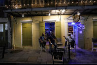 Patrons resume their socializing at Cuban Creations Cigar Bar in the French Quarter in New Orleans, after power was restored Wednesday, Oct. 28, 2020. Hurricane Zeta passed through earlier Wednesday, leaving much of the city and metro area without power. (AP Photo/Gerald Herbert)