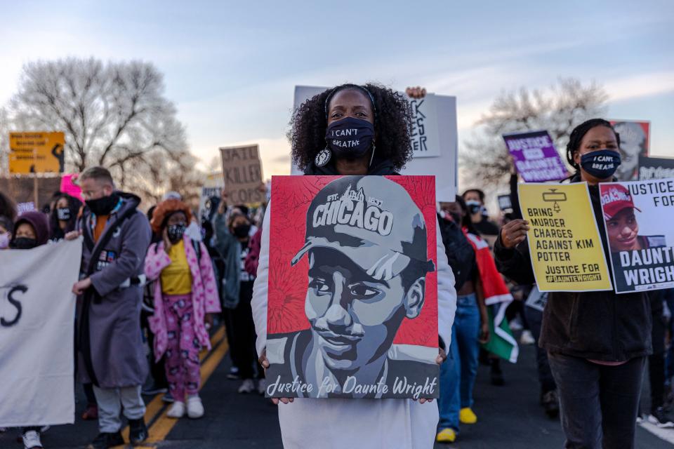 Demonstrators hold posters of Daunte Wright during a protest near the Brooklyn Center Police Department in Minnesota on April 16. (Photo: KEREM YUCEL via Getty Images)