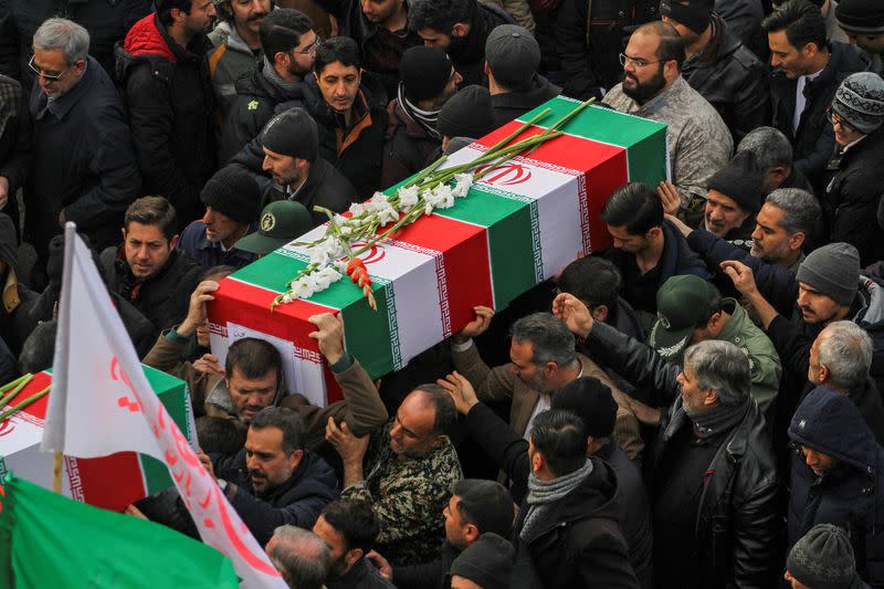 FILE PHOTO: Iranian people carry coffins during the funeral procession and burial of four Iranian victims of the Ukrainian plane crash in Iran, in Hamadan