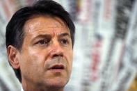 Italian Premier Giuseppe Conte listens to a journalist's question during a press conference at the foreign press club in Rome, Monday, Oct. 22, 2018. (AP Photo/Gregorio Borgia)