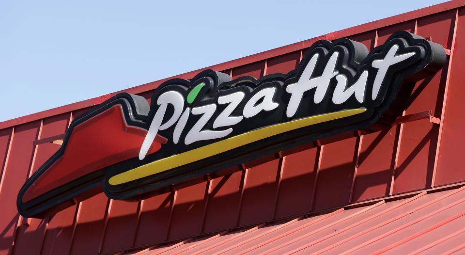 This Tuesday, Jan. 24, 2017, photo shows a Pizza Hut sign at a restaurant in Miami. Yum Brands, Inc., which operates Taco Bell, KFC and Pizza Hut, reports earnings, Thursday, Aug. 3, 2017. (AP Photo/Alan Diaz)