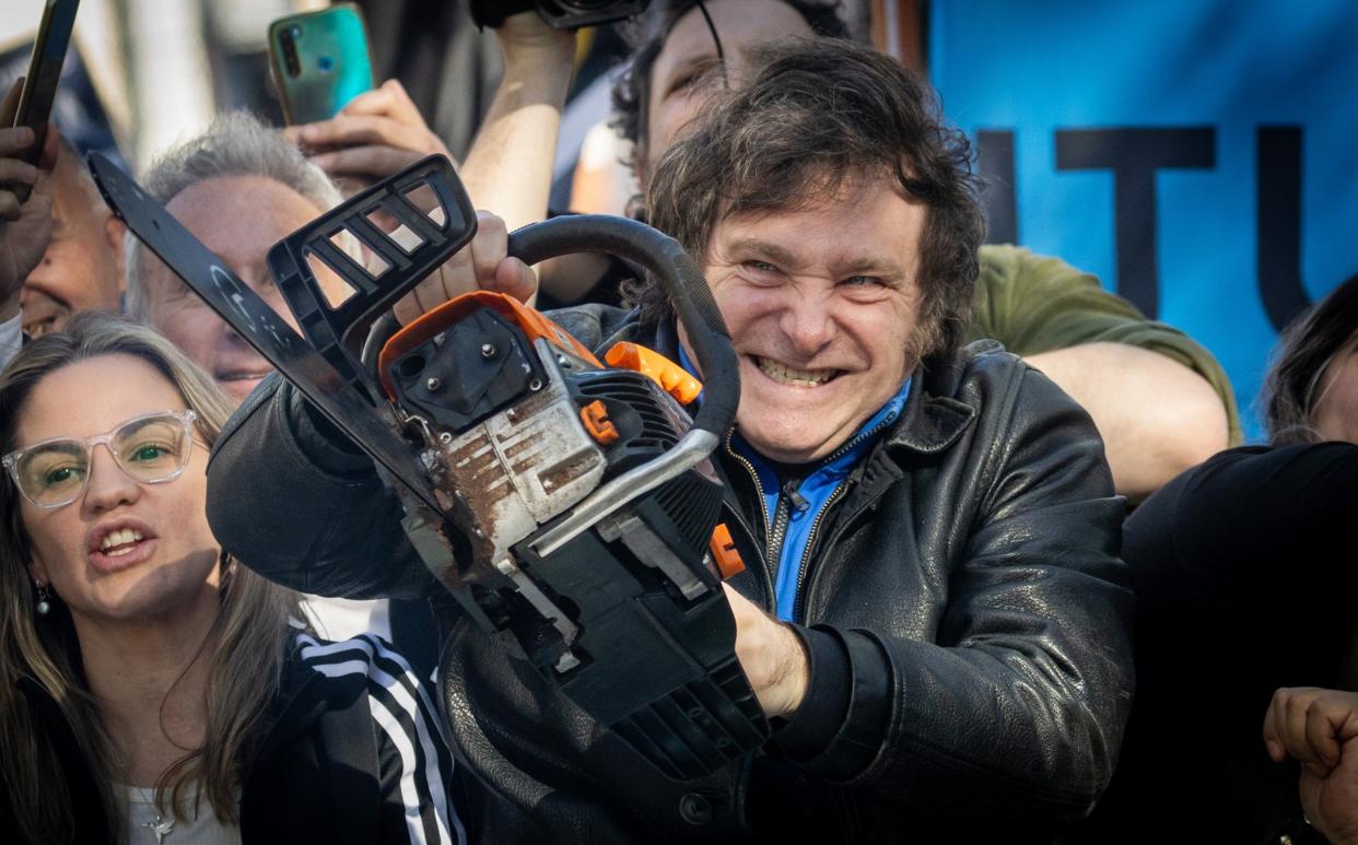 Javier Milei of La Libertad Avanza lifts a chainsaw