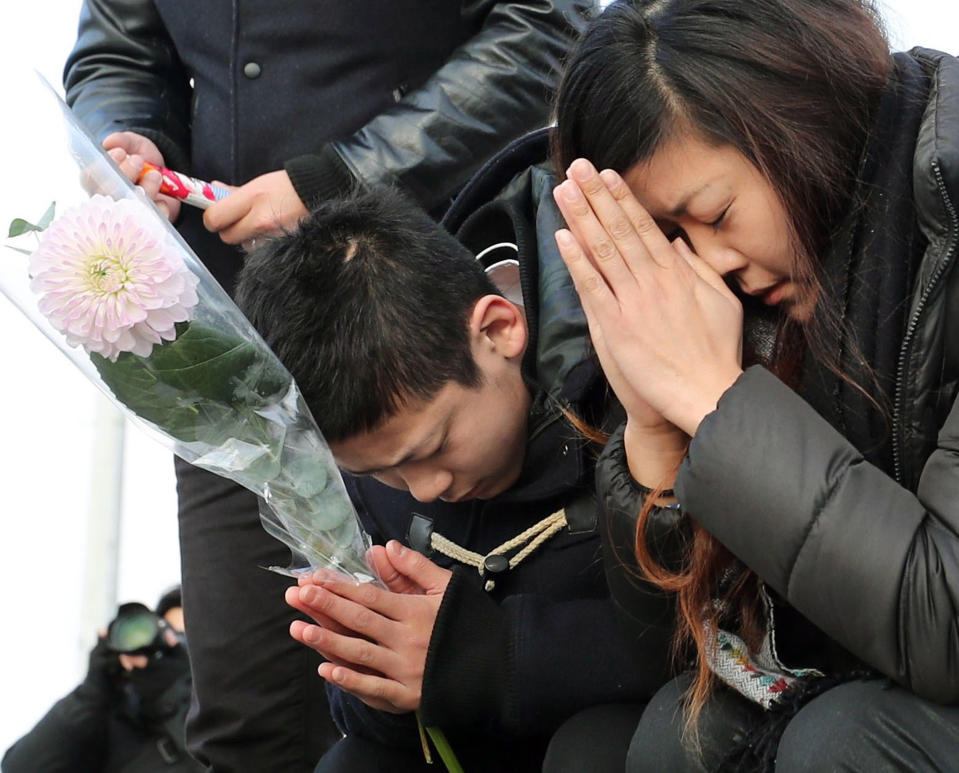 People offer prayers in front of a memorial for the victims of the 2011 earthquake and tsunami in Sendai, Miyagi prefecture, Japan Saturday, March 11, 2017. On Saturday, Japan is marking the anniversary of the disaster that struck the nation. (Jun Hirata/Kyodo News via AP)