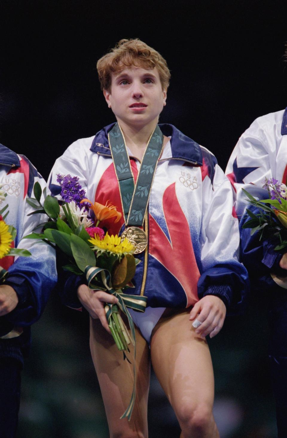 <p>Heroism at its finest. The 1996 ‘Magnificent Seven’ gymnastics team needed to win the vault in order to beat Russia. Kerri Strug was the last to compete and in her first vault attempt she fell and heard a crack from her ankle. Pushing through the pain, Strug stuck the vault landing, giving the U.S. their first-ever team gold. (Getty) </p>