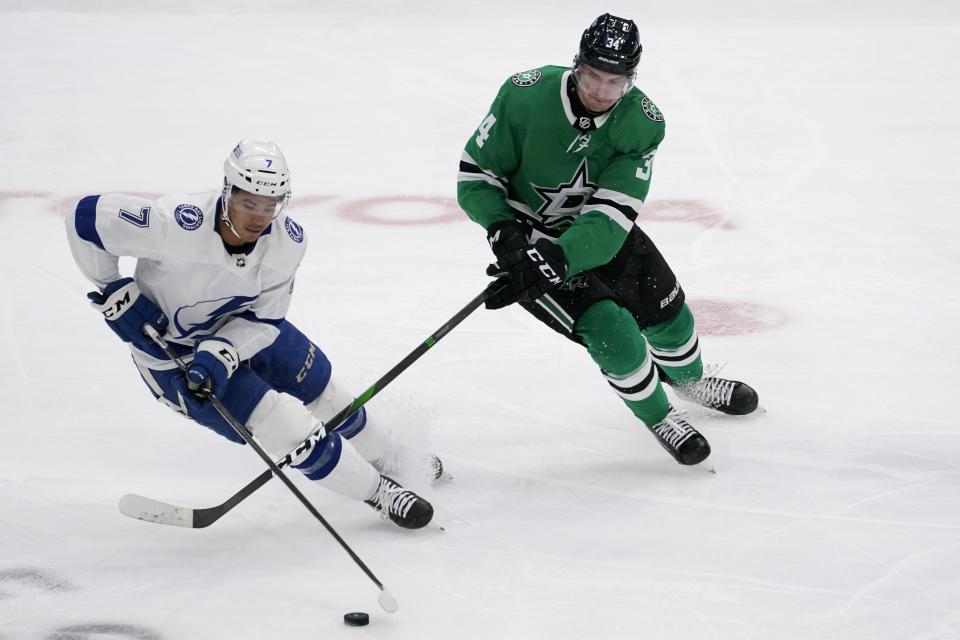 Tampa Bay Lightning right wing Mathieu Joseph (7) intercepts a pass intended for Dallas Stars' Denis Gurianov (34) in the second period of an NHL hockey game in Dallas, Tuesday, March 2, 2021. (AP Photo/Tony Gutierrez)