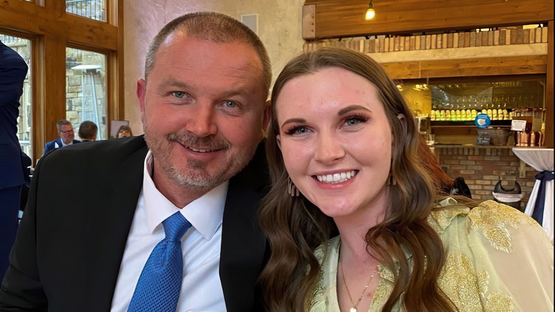 A man and a young woman in formal clothing.