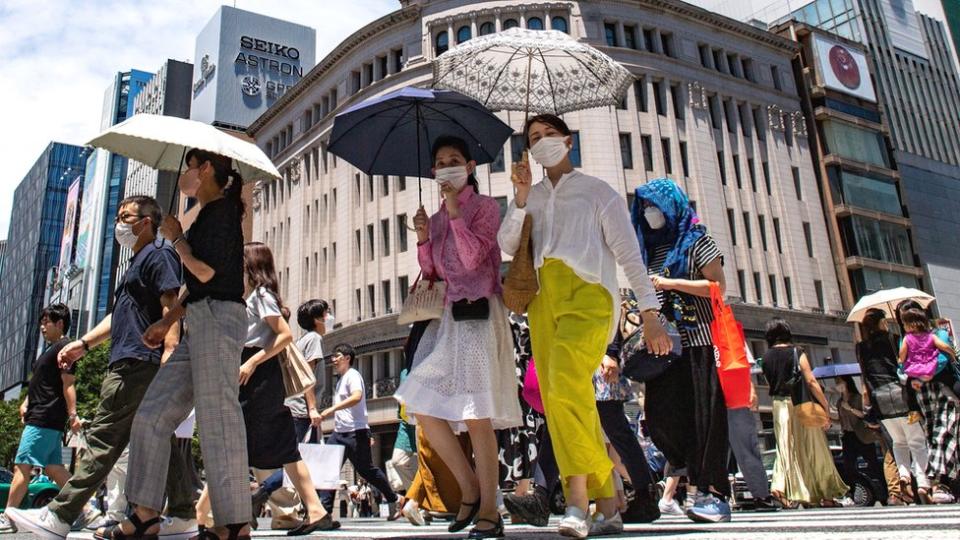 Pedestrians walk on a street in Tokyo's Ginza district.