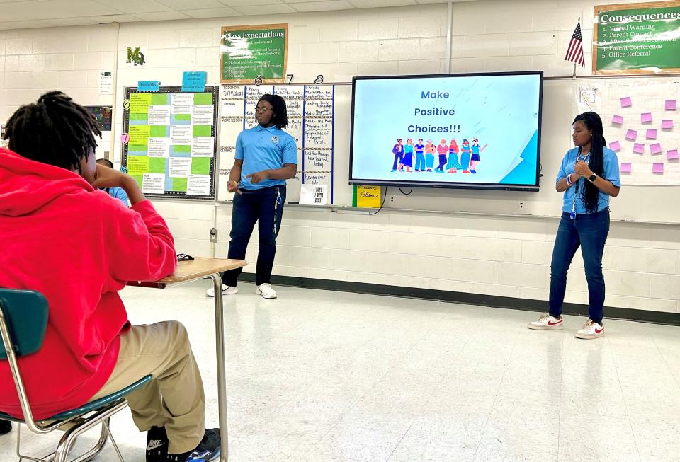 Jenkins High School students Lebron Jackson (standing left) and Olivia Jones (standing right) present to Myers Middle School students as part of the Mediation Center of the Coastal Empire's Positive Peer Influencer program on March 19, 2024