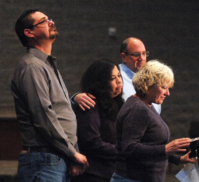 Krystle Dikes' father Shaun Dikes, left, looks heavenward as his wife Charlotte, right, address the media during a press conference at the First Baptist Church in Bristol, Ind. Saturday, Jan. 18, 2014. Dikes' mother Juanita Whitacre and her husband, David stand with the Dikes. Shawn Walter Bair of Elkhart shot and killed Krystle Dikes Wednesday night at a Martin's Super Market in Elkhart. He also killed 44-year-old shopper Rachelle Godfread before being fatally shot by police. (AP Photo/The Elkhart Truth, Jennifer Shephard)