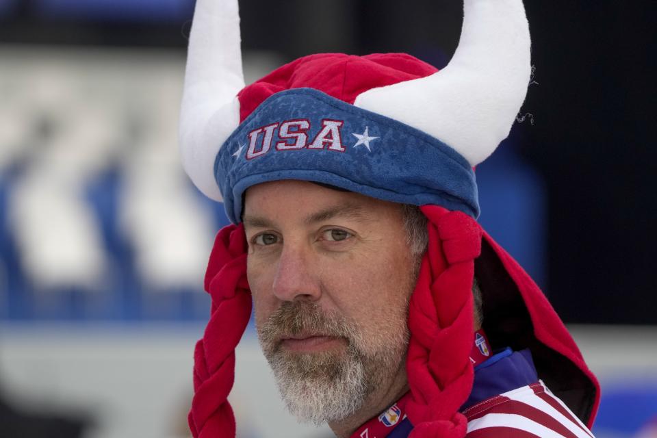 A fan waits for the start of the opening ceremony for the Ryder Cup at the Whistling Straits Golf Course Thursday, Sept. 23, 2021, in Sheboygan, Wis. (AP Photo/Charlie Neibergall)