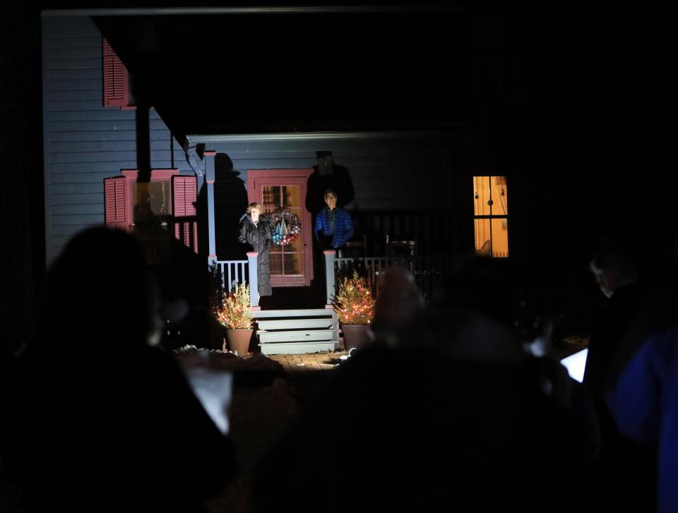 Diane Topkis and Bryan Lee listen from their porch as a group of carolers from Saint Margaret's Episcopal Church in Staatsburg sing on December 14, 2022.
