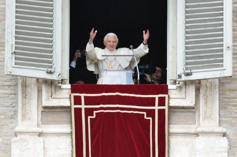 Pope Benedict XVI gestures from the window of his residence in St Peter's Square in the Vatican on February 24, 2013, during his last Sunday prayer before stepping down. The 85-year-old leader of the world's 1.2 billion Catholics said earlier this month he will be stepping down because he lacks the strength to carry on in an announcement that shocked the world