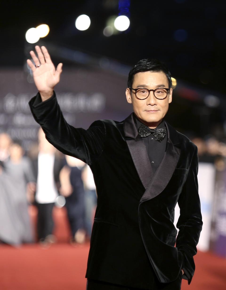 Hong Kong actor Tony Leung poses for photographers on the red carpet at the 50th Golden Horse Film Awards in Taipei