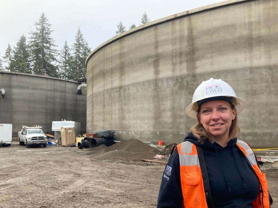 Laura Farthing, Chief Engineer for the Eugene Water & Electric Board's E 40th drinking water reservoir, stands in front of the site's two 7.5 million gallon tanks.